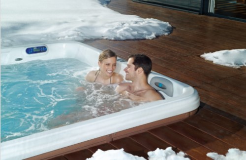 A couple enjoying the swim spa in mid-winter