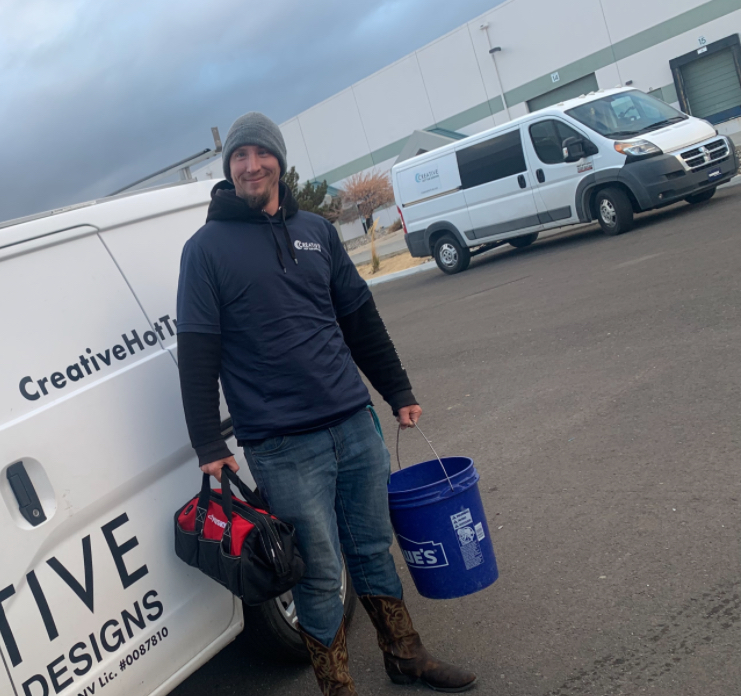 Water care technician Ian from Creative Hot Tub Designs, holding equipment and bucket, standing in front of service van in Sparks, NV.