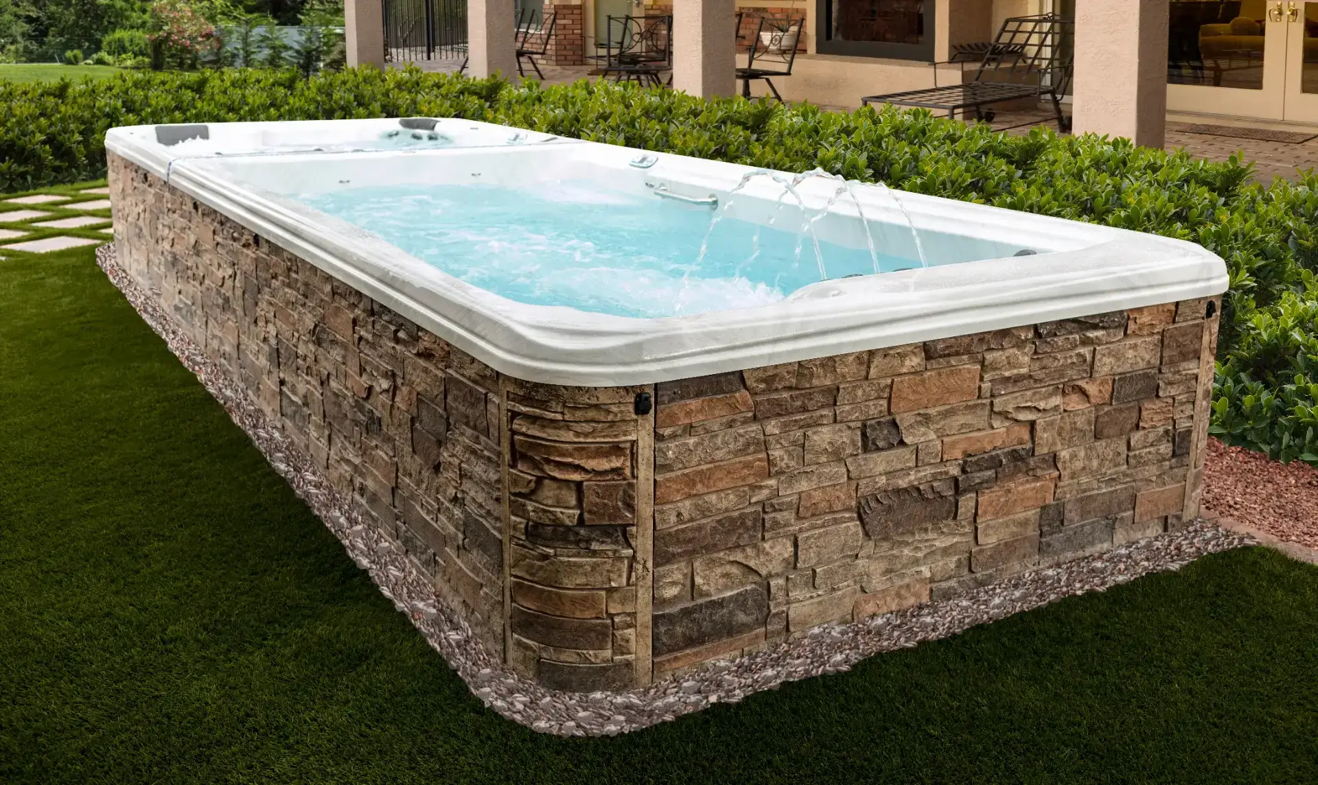 TidalFit Swim Spa with adjustable swim jets and ample seating, designed for relaxation and exercise in a backyard setting, offered by Creative Hot Tub Designs in Reno, NV.