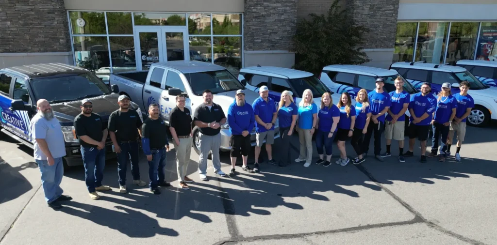 Creative Hot Tub Designs team in front of their Reno, NV location, showcasing commitment to quality service and community, with branded vehicles visible.