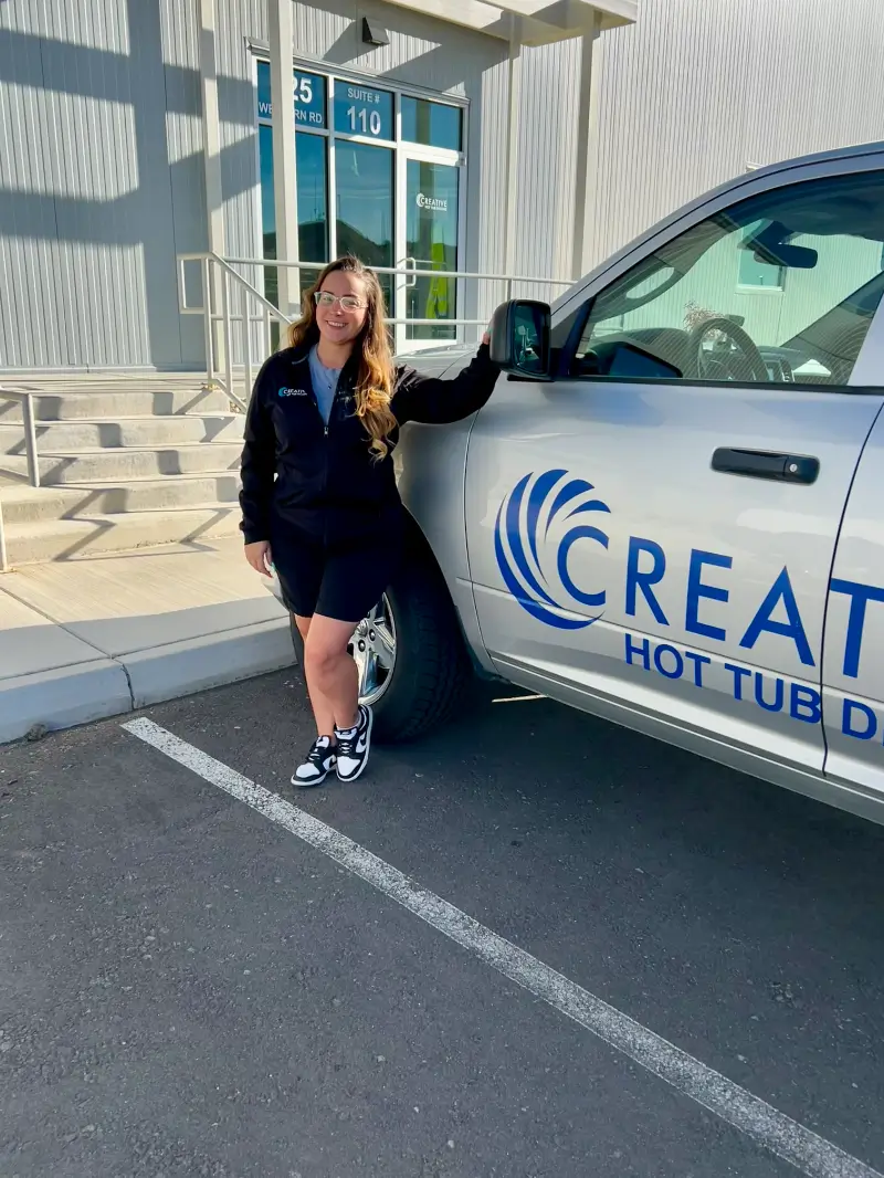 Natasha, Service Manager at Creative Hot Tub Designs, standing next to company vehicle outside their Sparks, NV location.